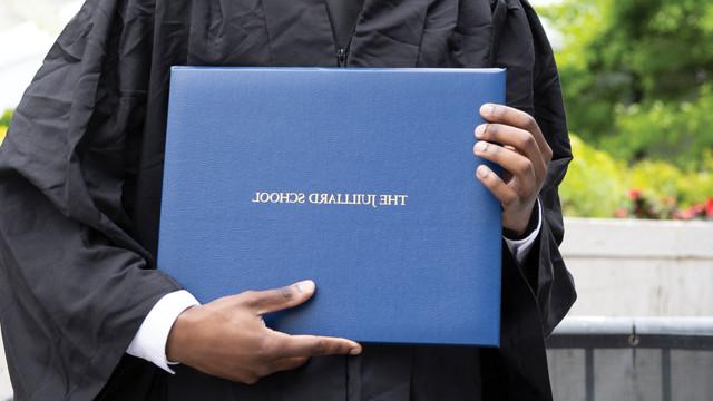 graduate holding diploma