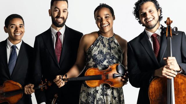 smiling string quartet posing for a photo