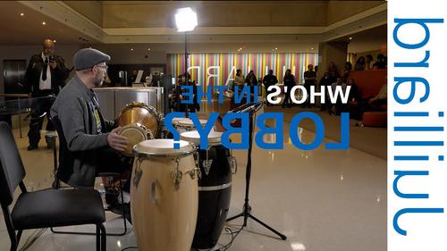 Man playing drums in Juilliard lobby