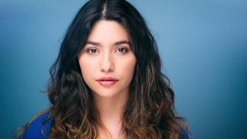 Headshot of Gabriela Torres against a blue background